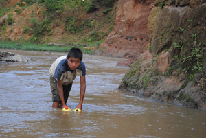 Boy Collecting Dirty Water